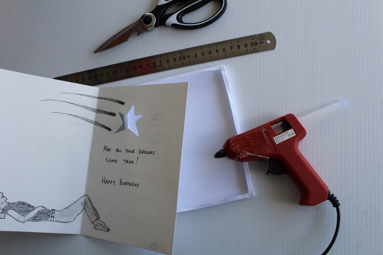 IMAGE: Create a cardboard cover for the back of the greetings card to cover the electrical circuit. Consider using a hot glue gun to attach the cover to the back of the card once all components are tested and installed. The card is now complete. 